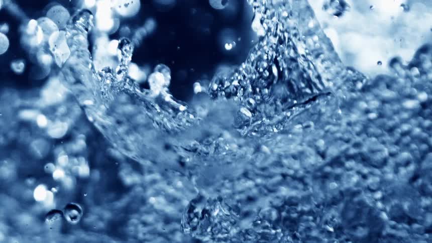 Explosion of blue water droplets and splashes in intense motion