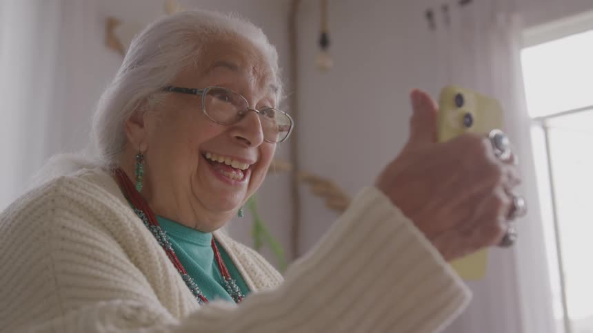 Elderly woman smiling during a video call