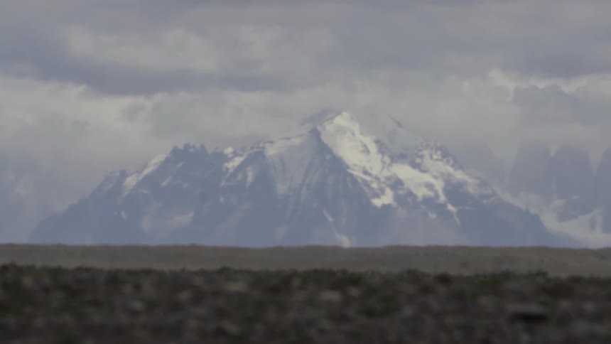 A large mountain is covered with snow in the distance