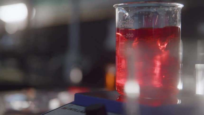 The machine is turned on to stir a beaker in the lab