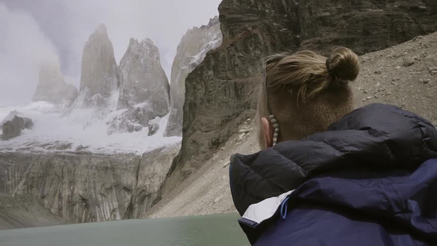A man is hiking on a mountain in the snow