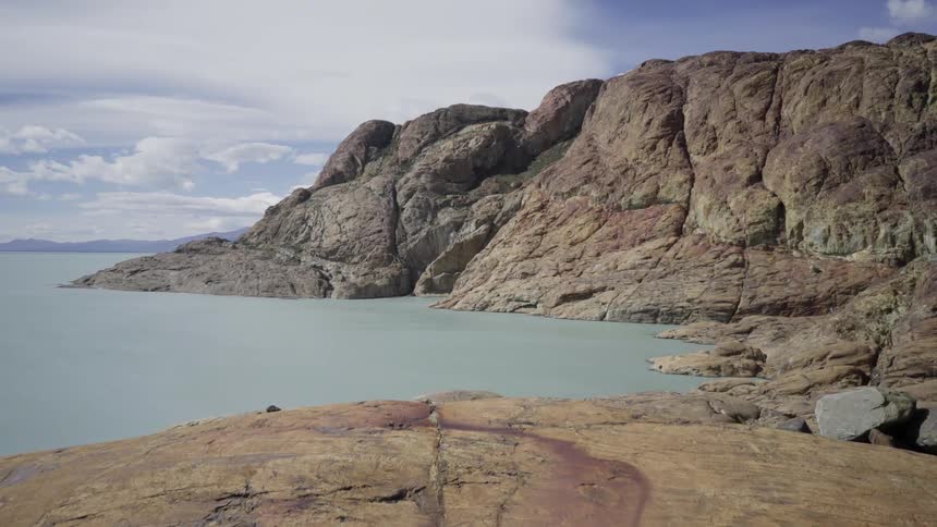 The mountain is all rock and lined with water