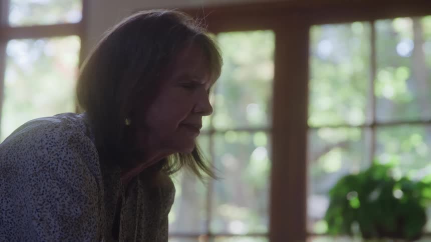 Close up portrait of a middle aged woman indoors during daytime