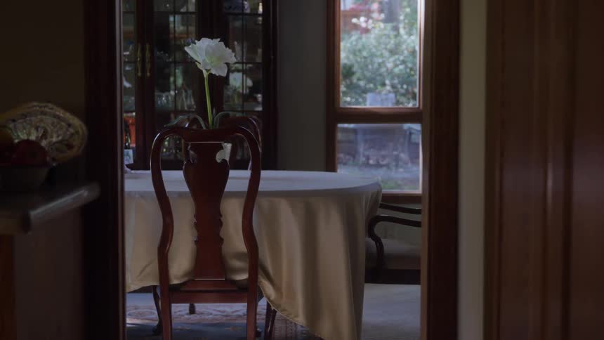A dining room with a table and chairs