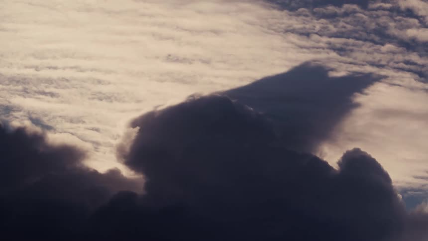 Dense cloud formation contrasts with the soft glow of the illuminated sky