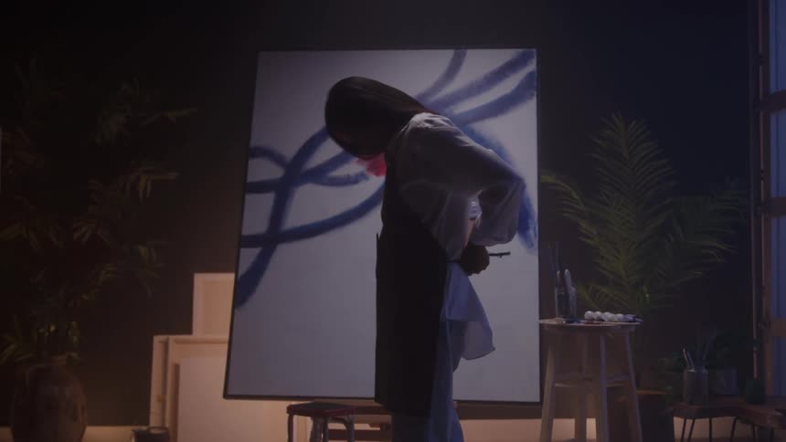 A woman gets ready to paint