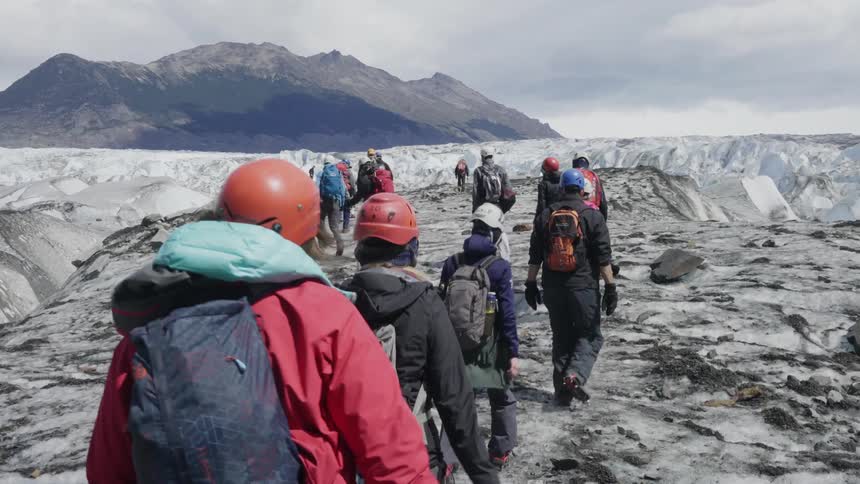 People are walking over an ice covered mountain