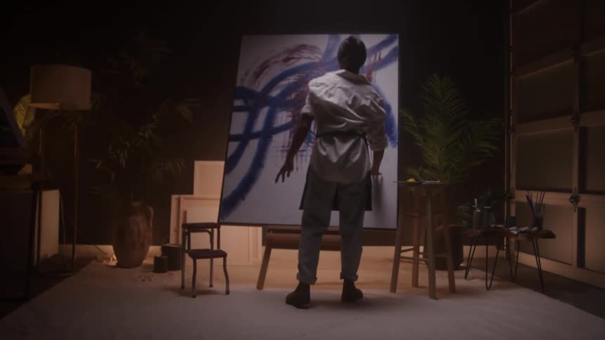 A woman paints on a canvas