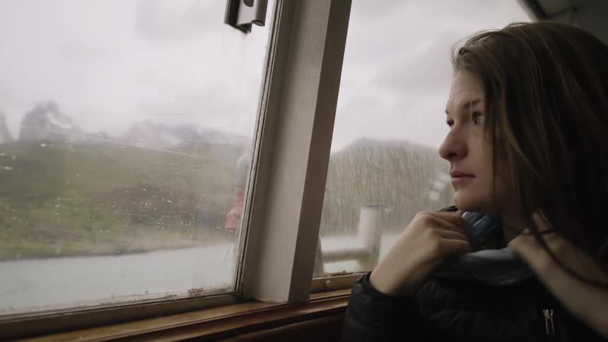 A woman is traveling in a vehicle