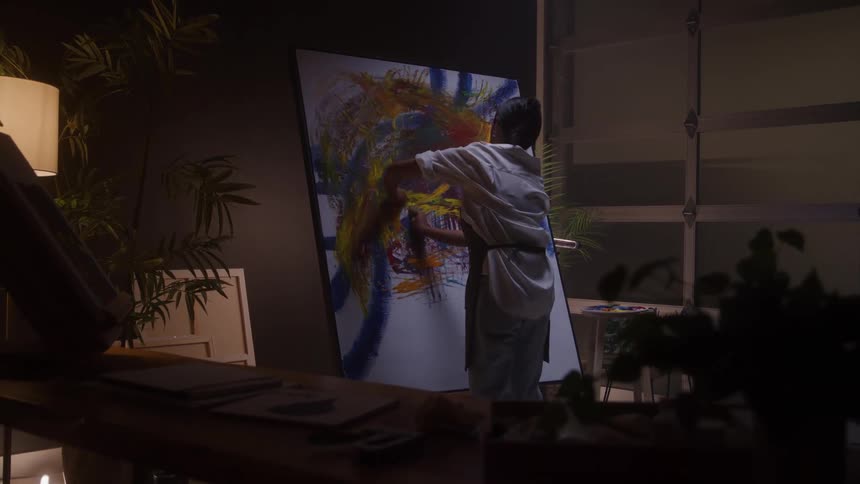 A person using their hands to paint a blank canvas with colorful colors