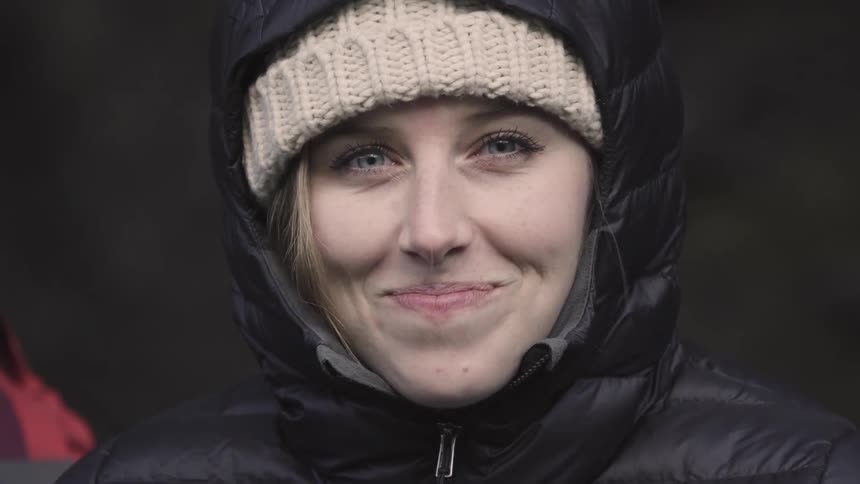 A woman looks up smiling