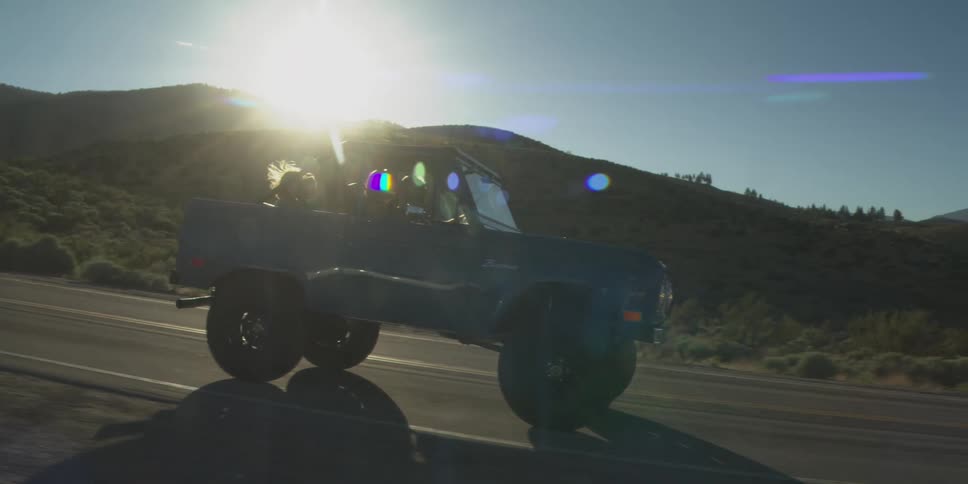 The vehicle drives on the highway in the desert