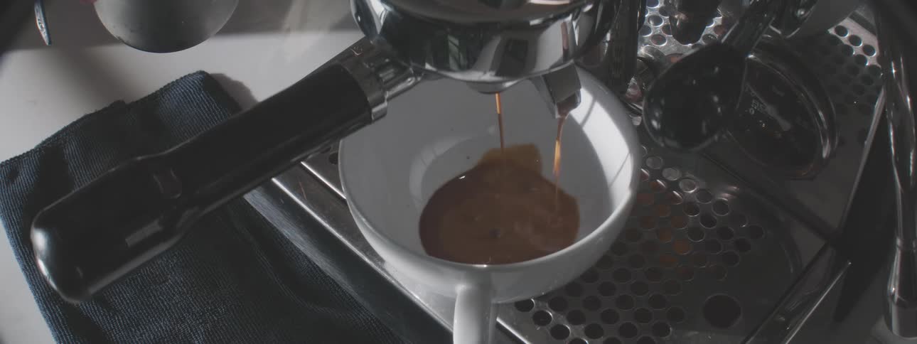 The person makes coffee with the machine