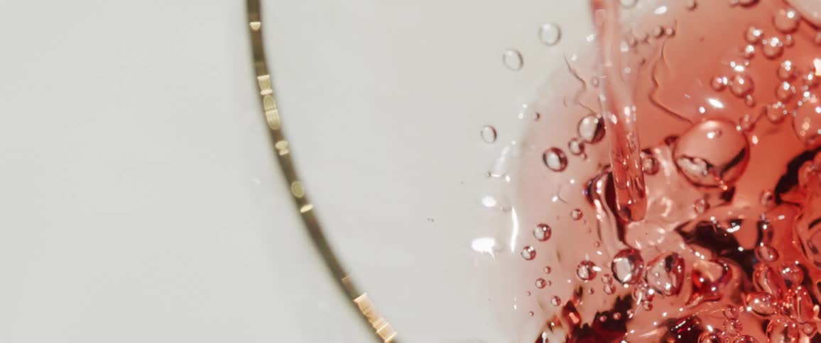 Wine is being poured into the glass