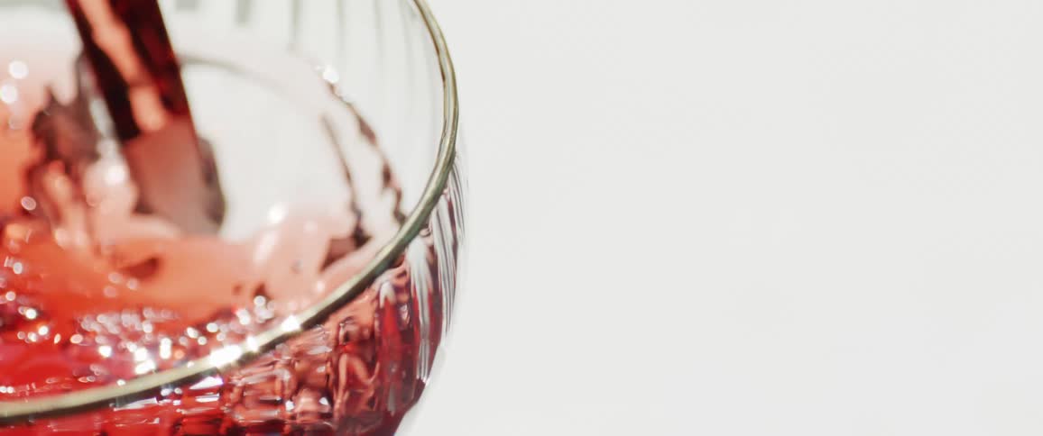 Red liquid poured into a glass