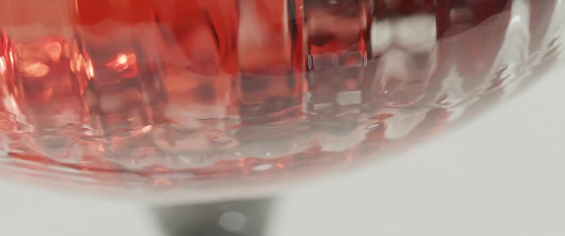 A drink is being poured into the glass