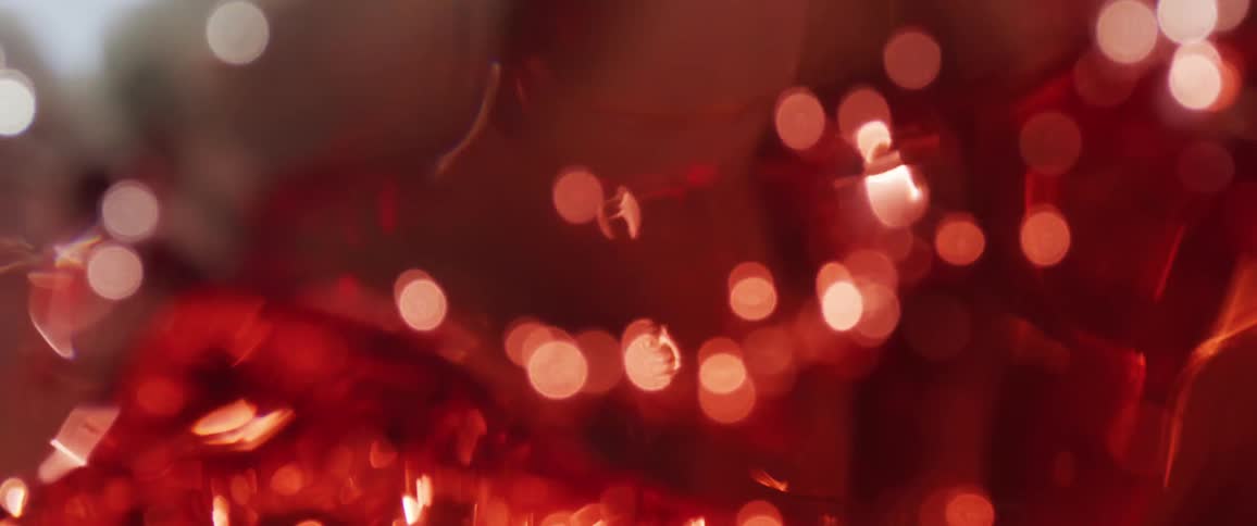 Red liquid in motion reflects intense lights