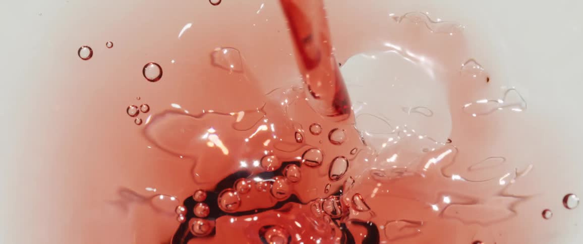 Red liquid being poured