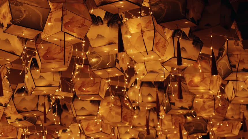 Decorated lanterns with golden lights create a glowing and cozy ceiling