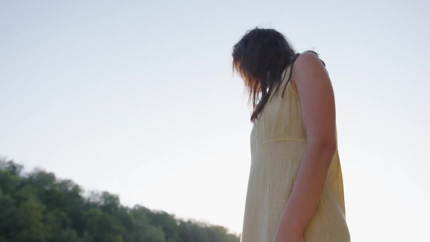 Woman walking outdoors under the soft evening light