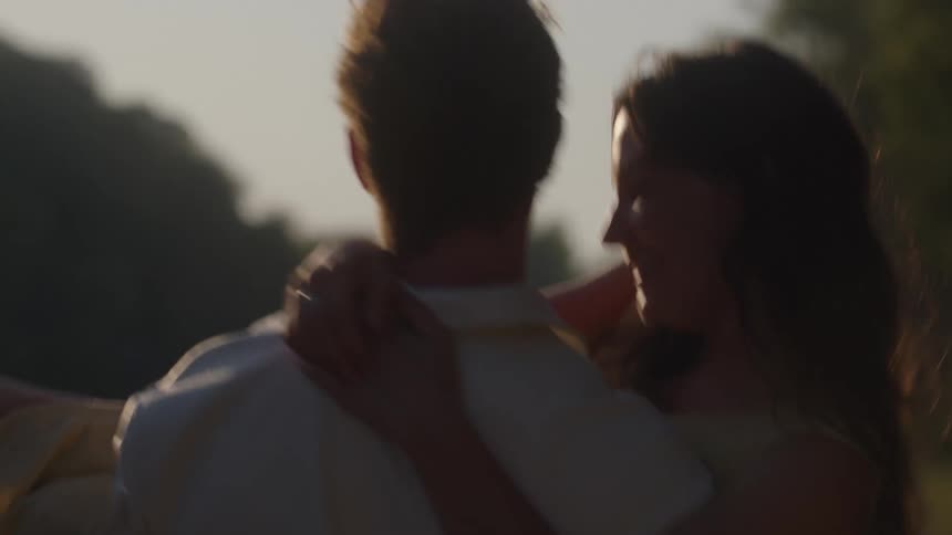 The man is spinning with a woman in his arms