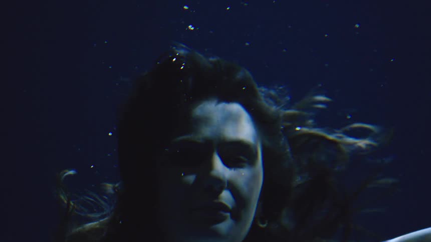 Young woman swimming underwater