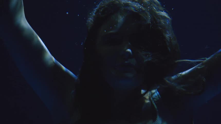 Closeup of a woman floating underwater