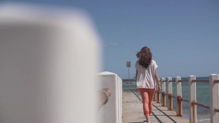 Woman walks down the boardwalk