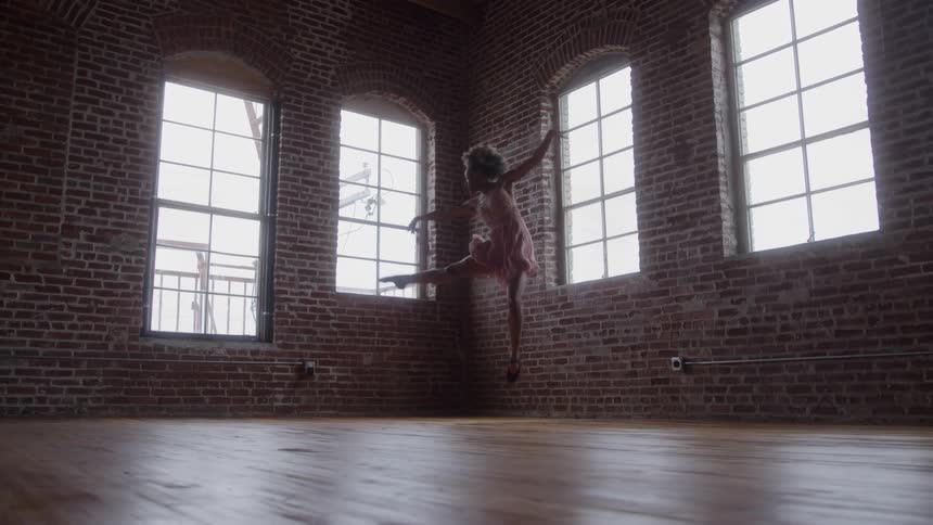 The girl jumps as she dances