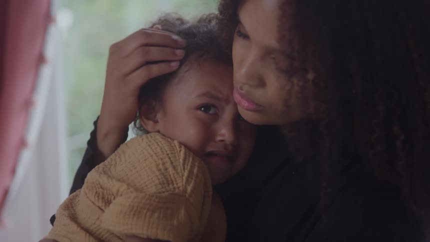 Mother hugs her crying daughter in her arms