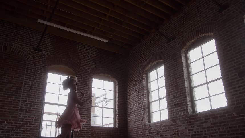 Woman dancing ballet in a pink dress