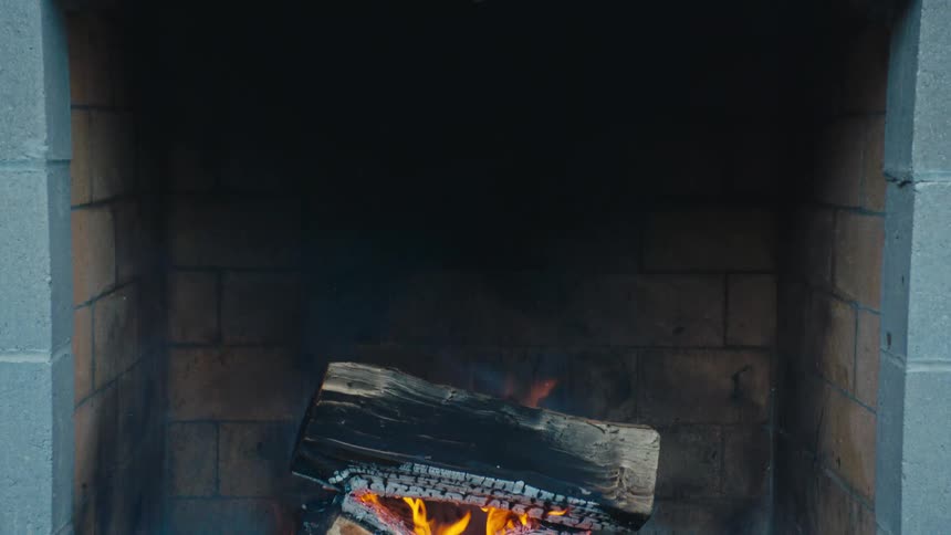 Logs burn in a fireplace