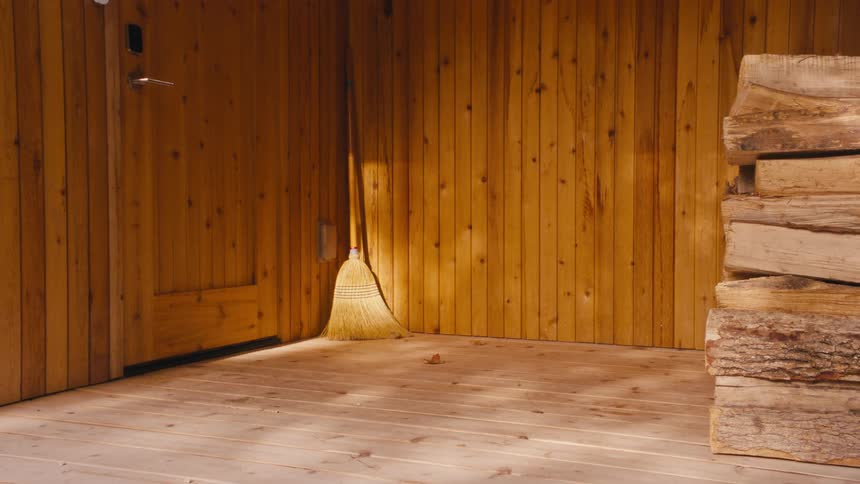 A broom in the corner of a room