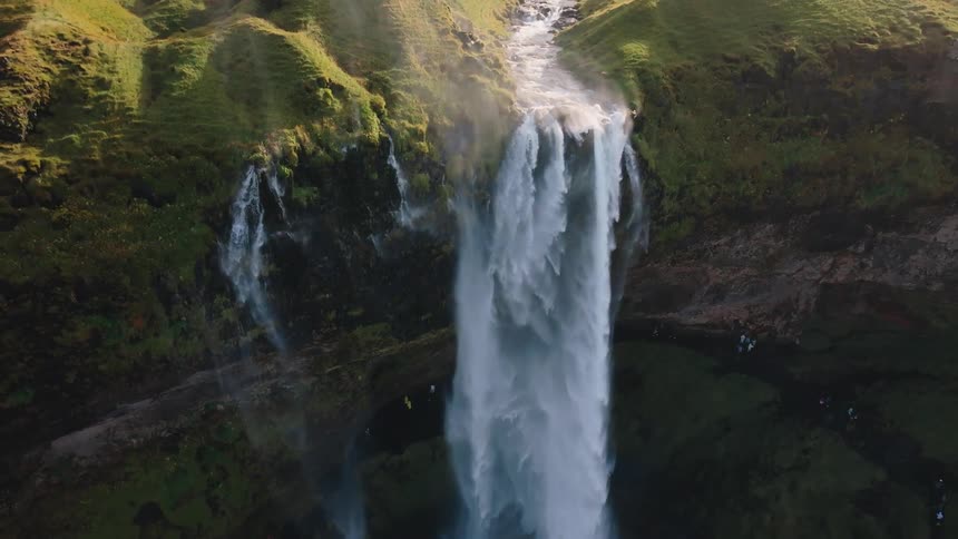 The large waterfall is filling the spring below