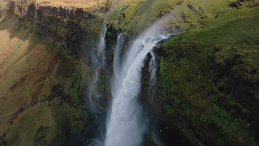 The stream runs off the cliff into a waterfall