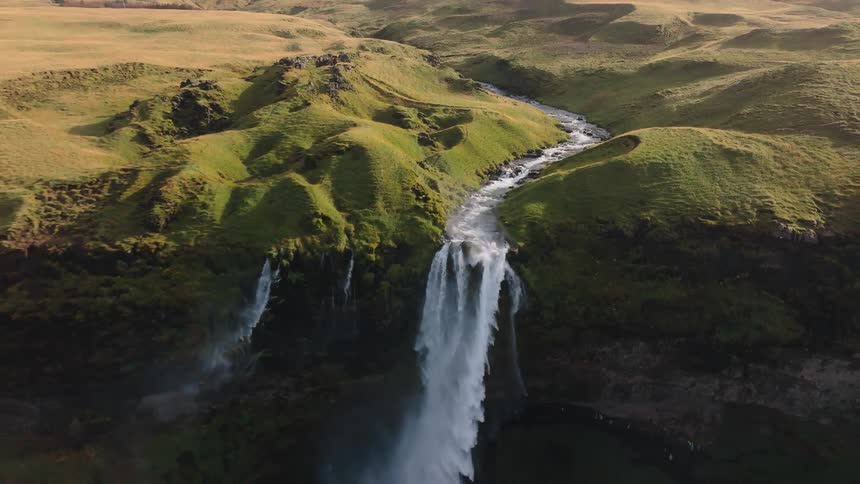 The stream runs over the mountains and off the cliff into a waterfall