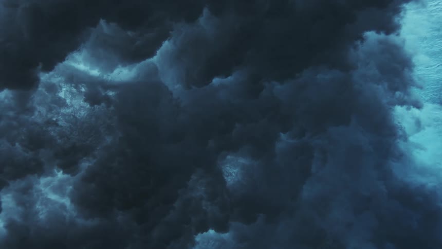 Bluish sediment cloud spreads underwater forming dynamic patterns in a subaquatic environment