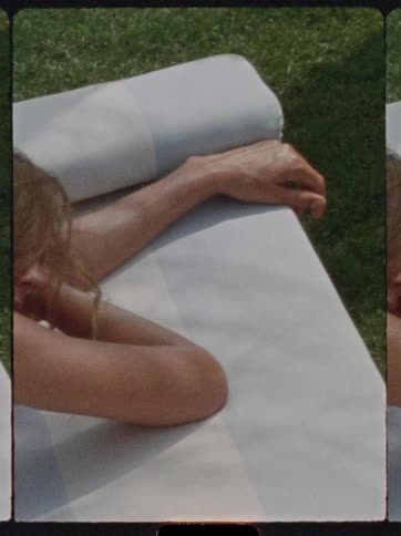 The woman is resting on the lawn