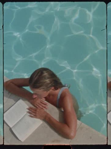 A woman reads while in the pool