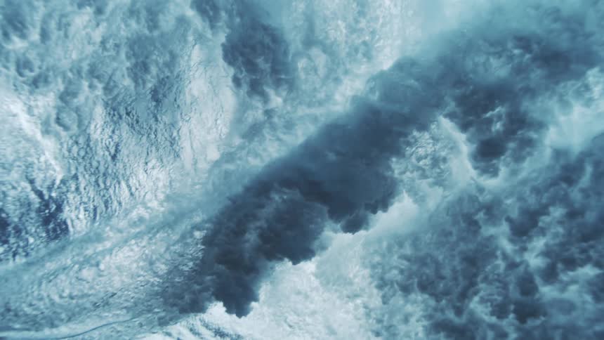 The surfboard glides across the surface of the water