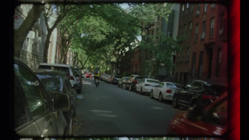 Cars drive on the small road in the city