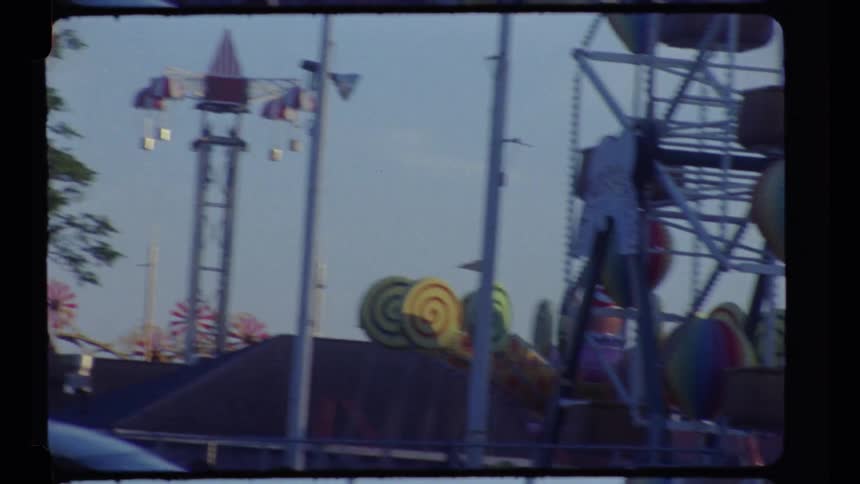 People taking various rides in an amusement park during daytime