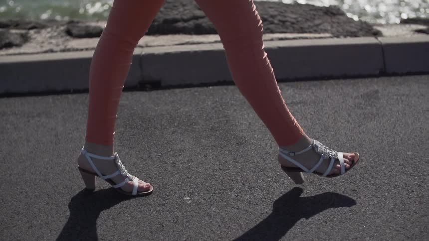 Woman wearing high heels walking