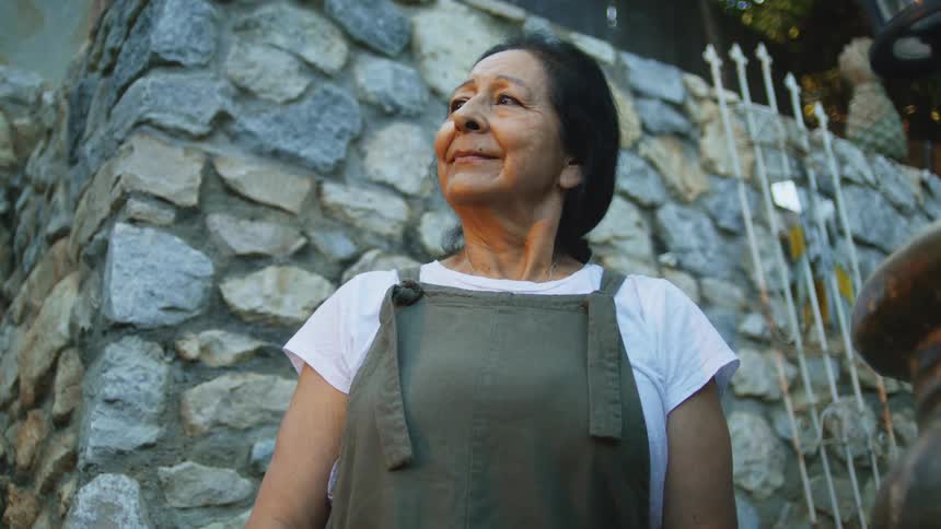 The woman smiles while she breaths heavily