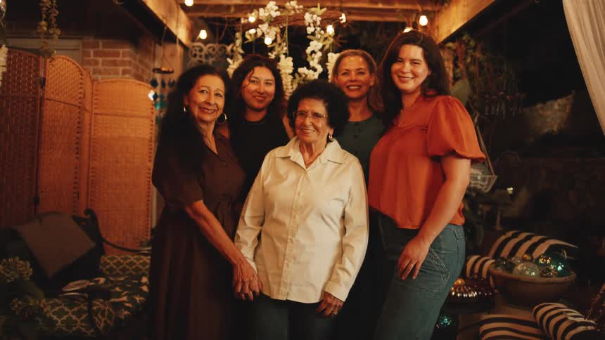 Group of women smiling in a warmly lit setting