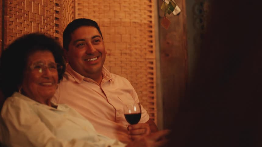 Family drink wine and dance together
