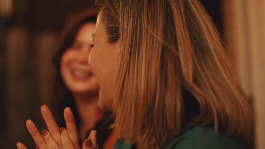 Women share a lively discussion and burst into laughter enjoying their time together