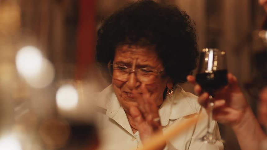 People celebrate by toasting with red wine