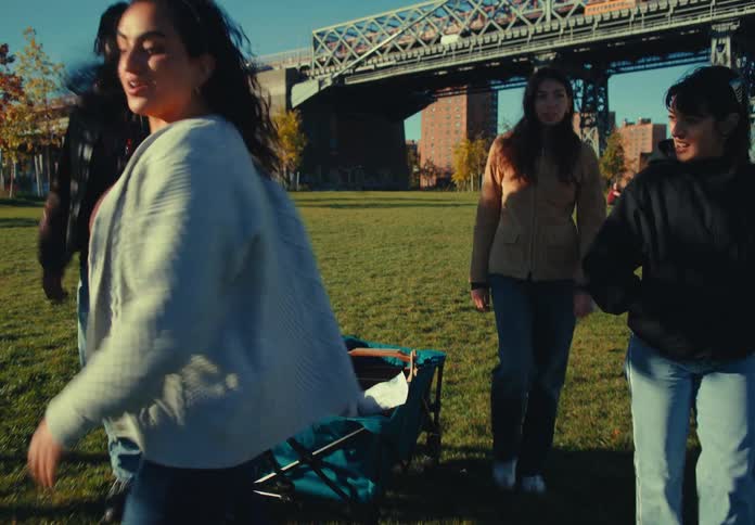Friends drag a wagon into the park to have a picnic