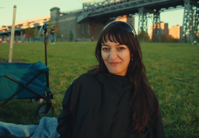 The woman is laughing by the bridge